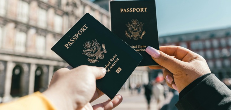 Two people holding passports