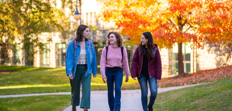 Three students walking on campus