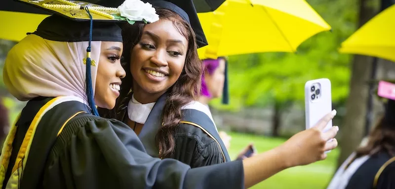 Students taking selfie at graduation