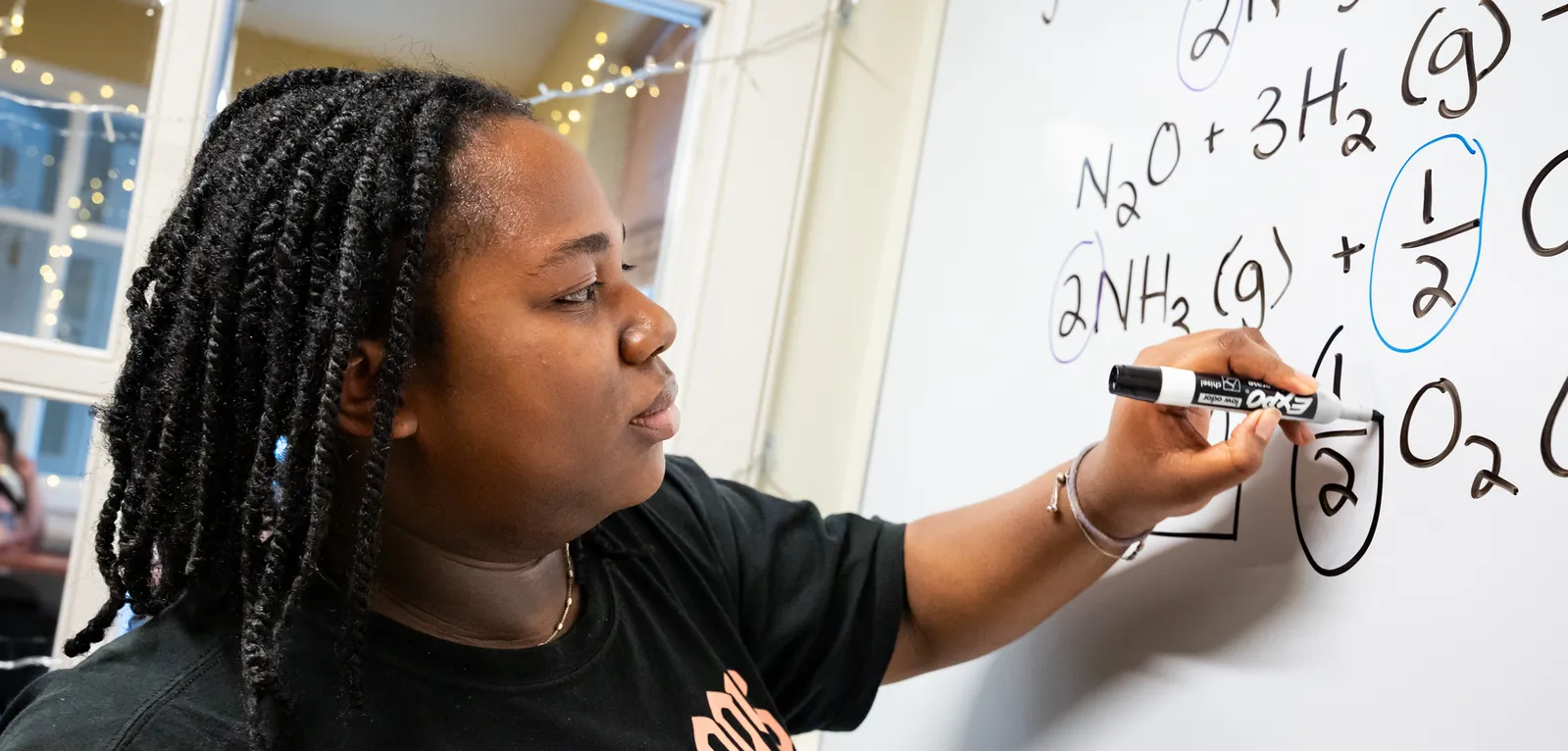 Student at white board in Q Center