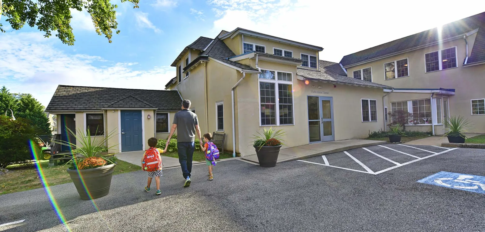Father walking two boys into school