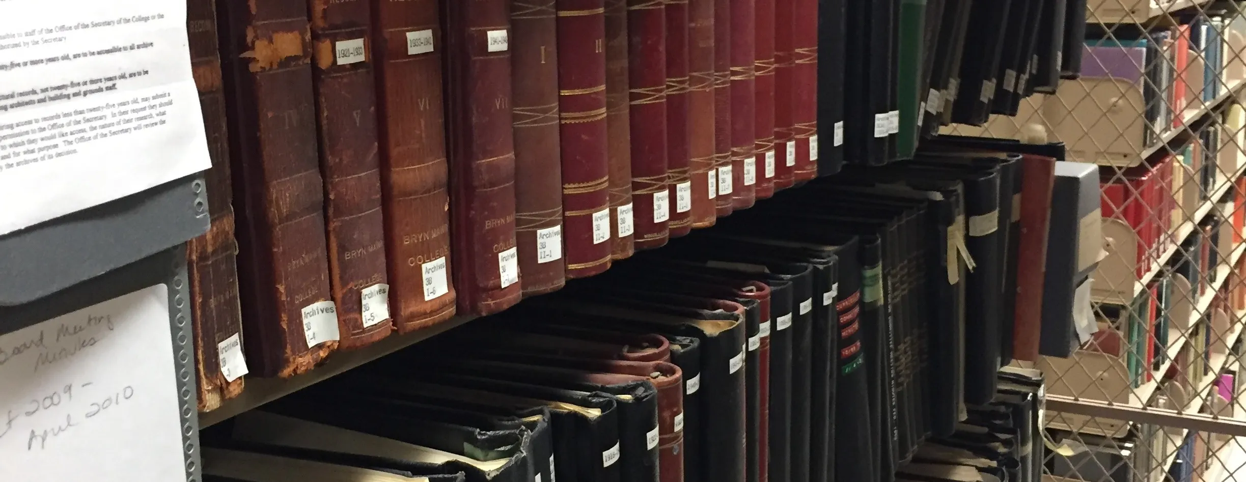 Image of hollinger boxes and bound volumes on shelf.