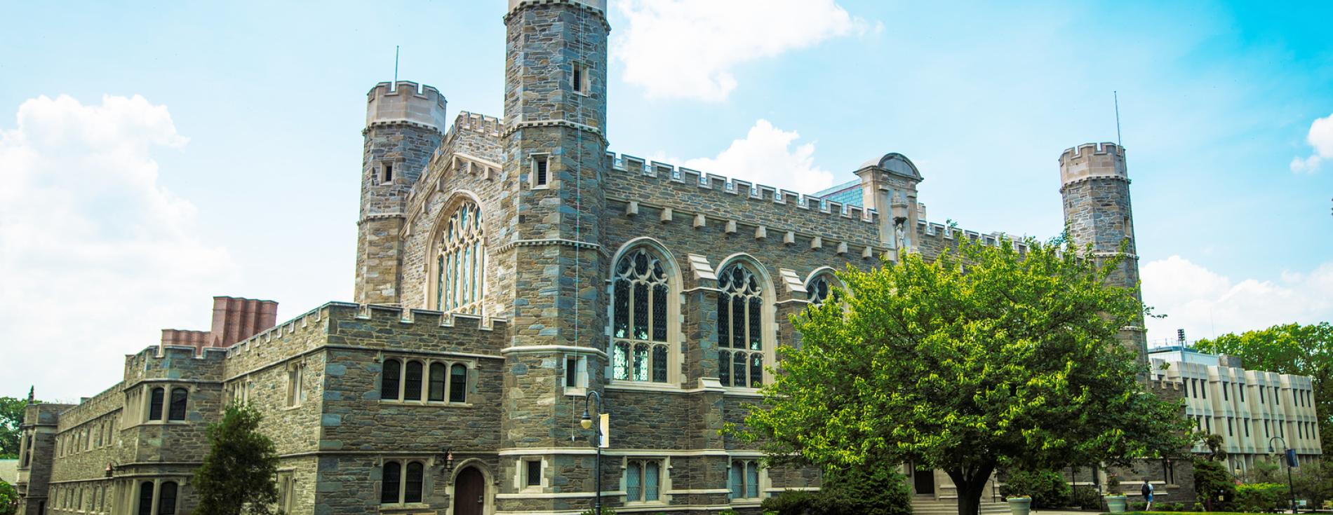 Large stone building with green grass