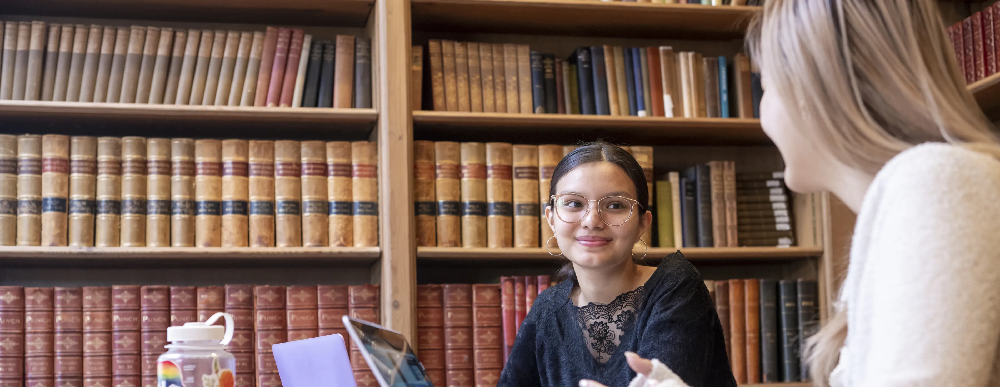 Two students discussing in the library