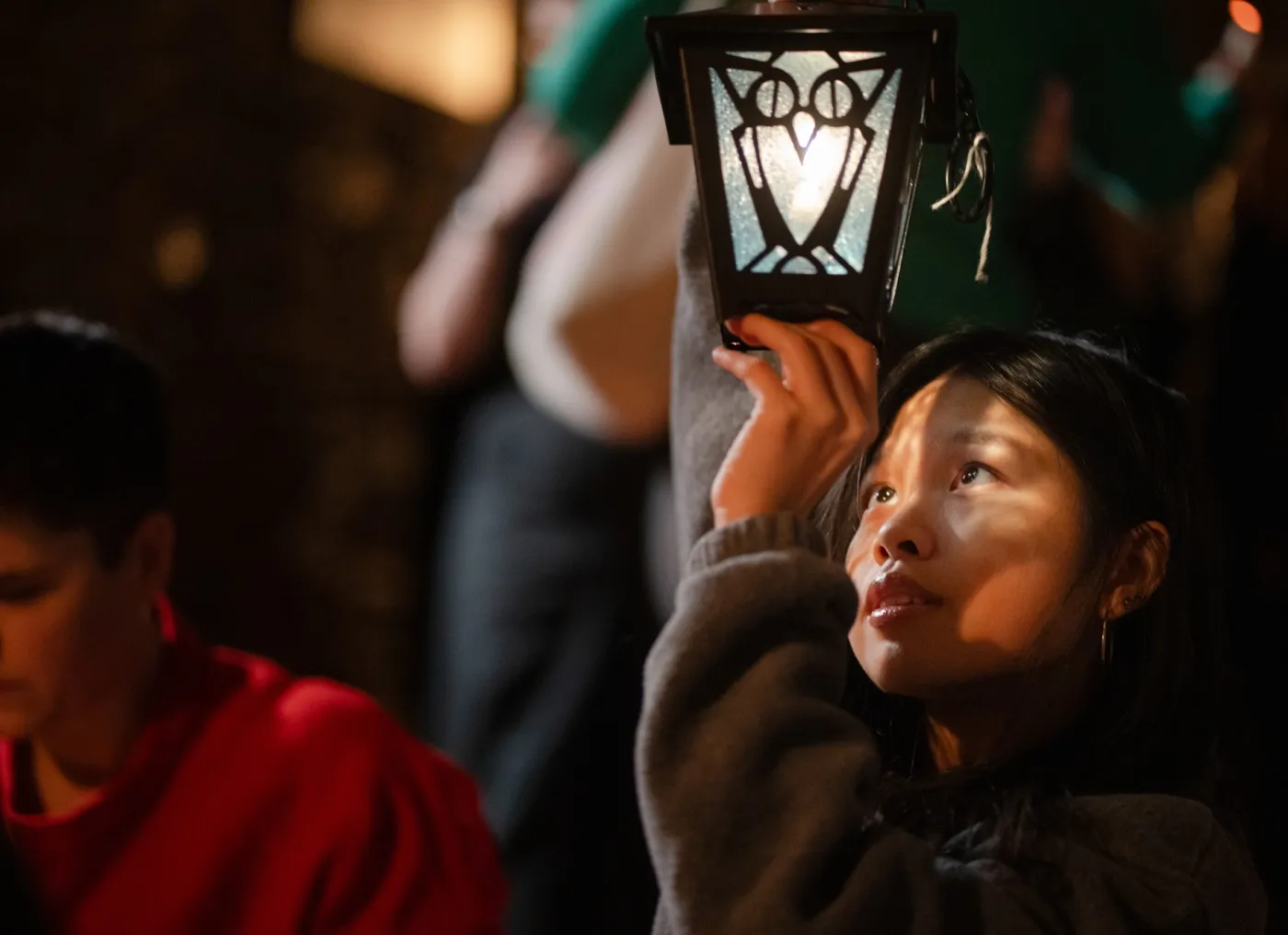 student looking at a lantern