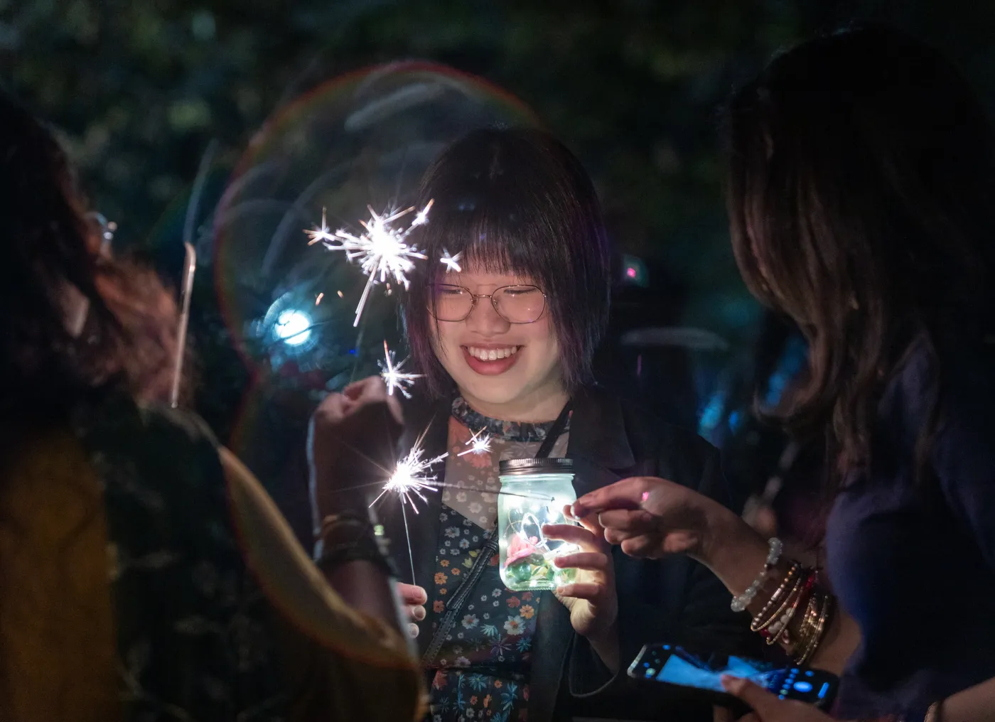 student holding a sparkler