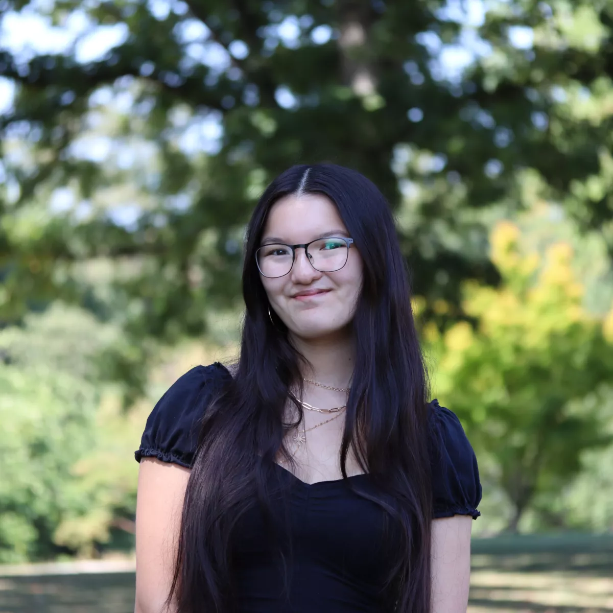 Sofia in a black shirt and glasses