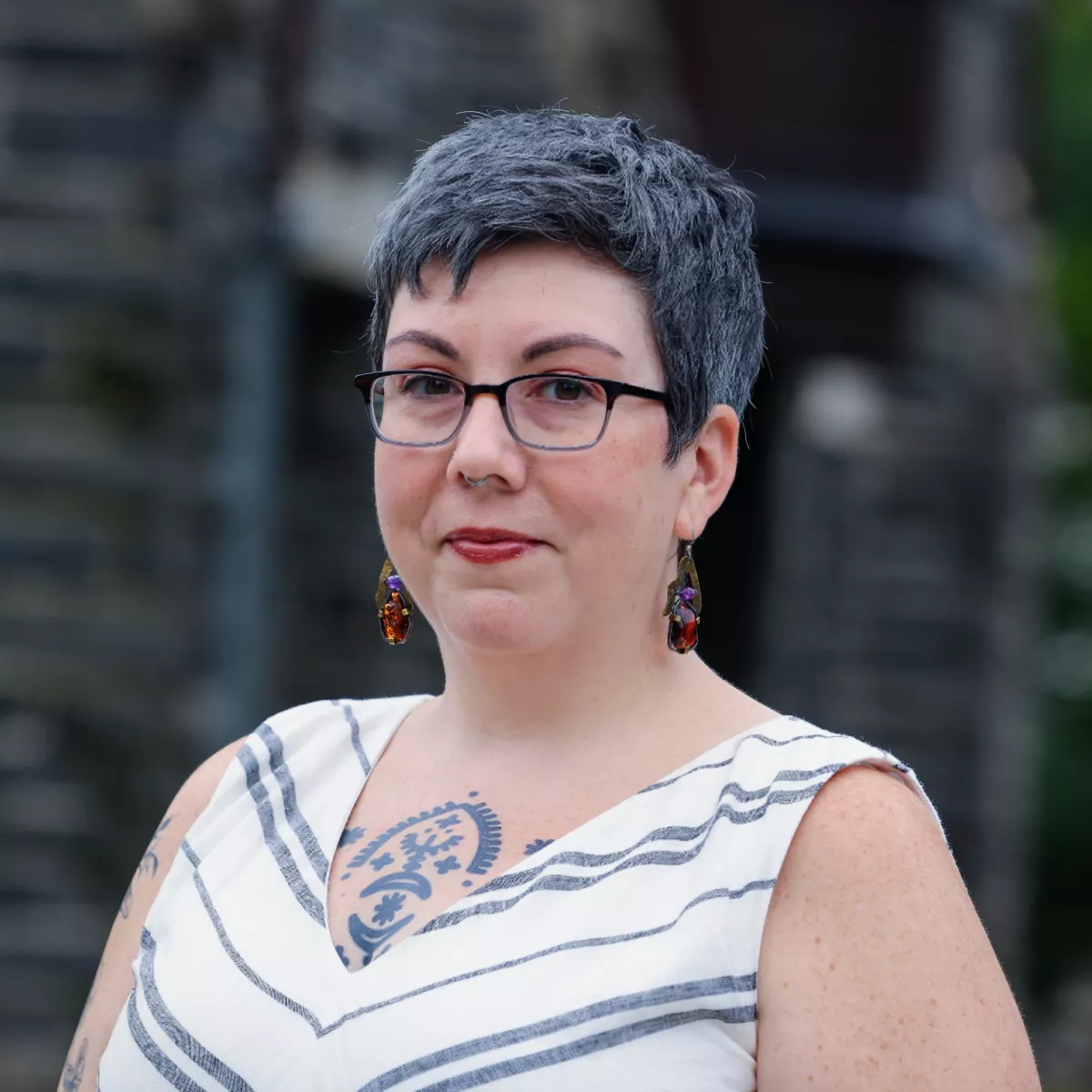 An image of staff member taken in front of a campus building