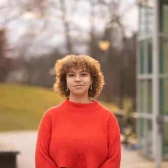 Leila in a red sweater
