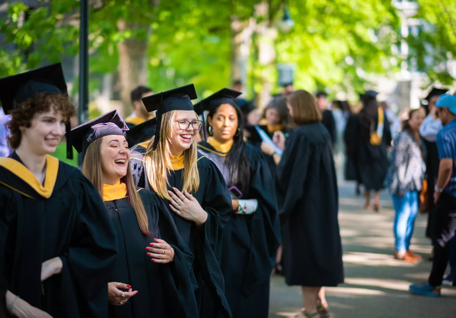 Graduate students lining up on Taylor Drive at Graduate Commencement