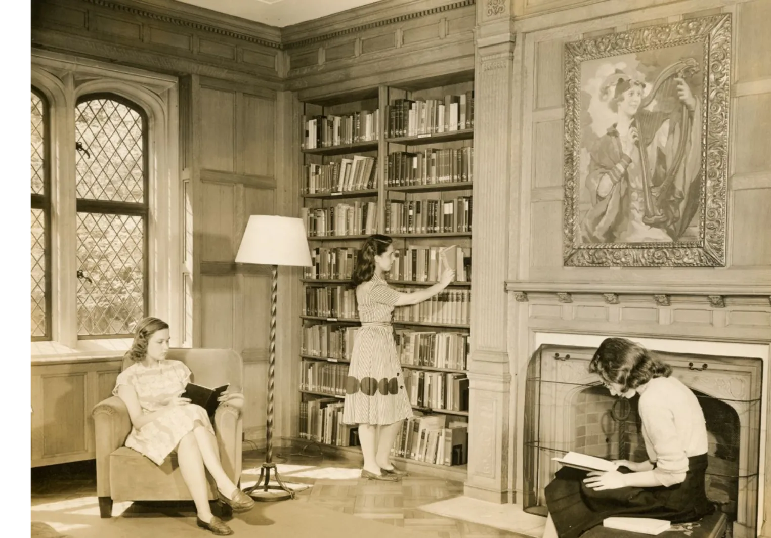Students in period typical clothing explore the shelves of the Quita Woodward Room