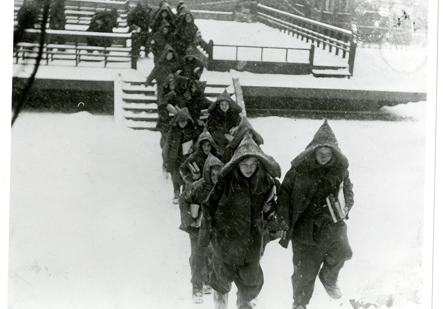 Children trekking through the snow near the Phebe Anna Thorne School's open air pagodas