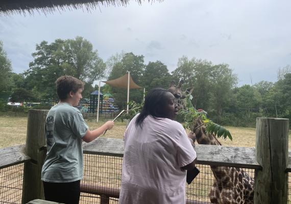 Isabel Oalicen at the Franklin Park Zoo feeding a giraffe