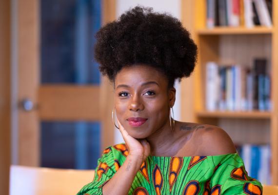 Chanelle Wilson seated at a table with a book