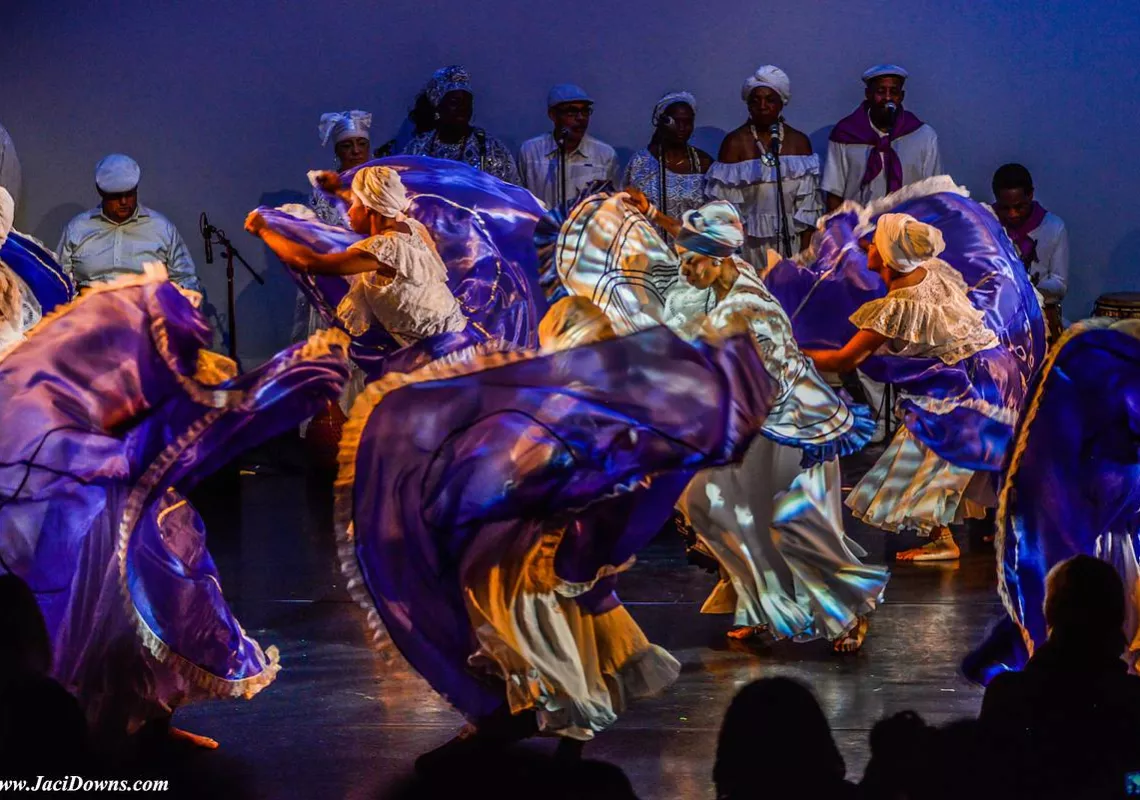 Dancers on stage in purple light