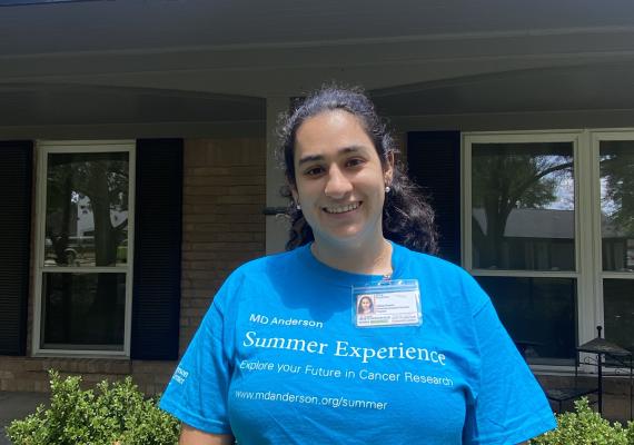 Fay Koyfman standing in front of a house. 