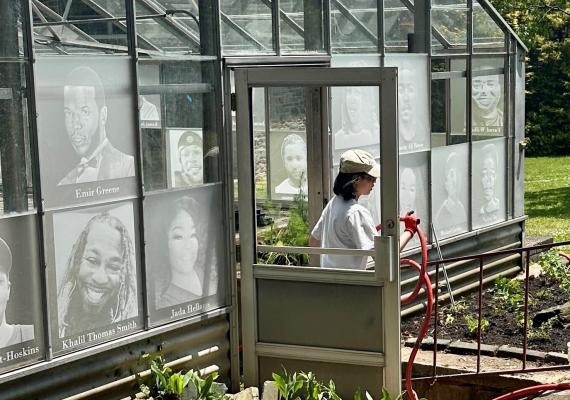 Person walking out of a garden greenhouse