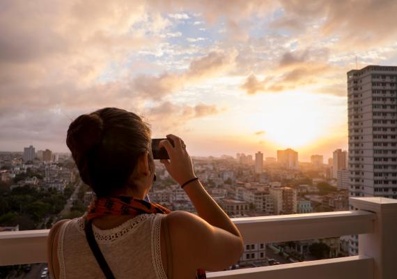 Student taking a photo from a balcony