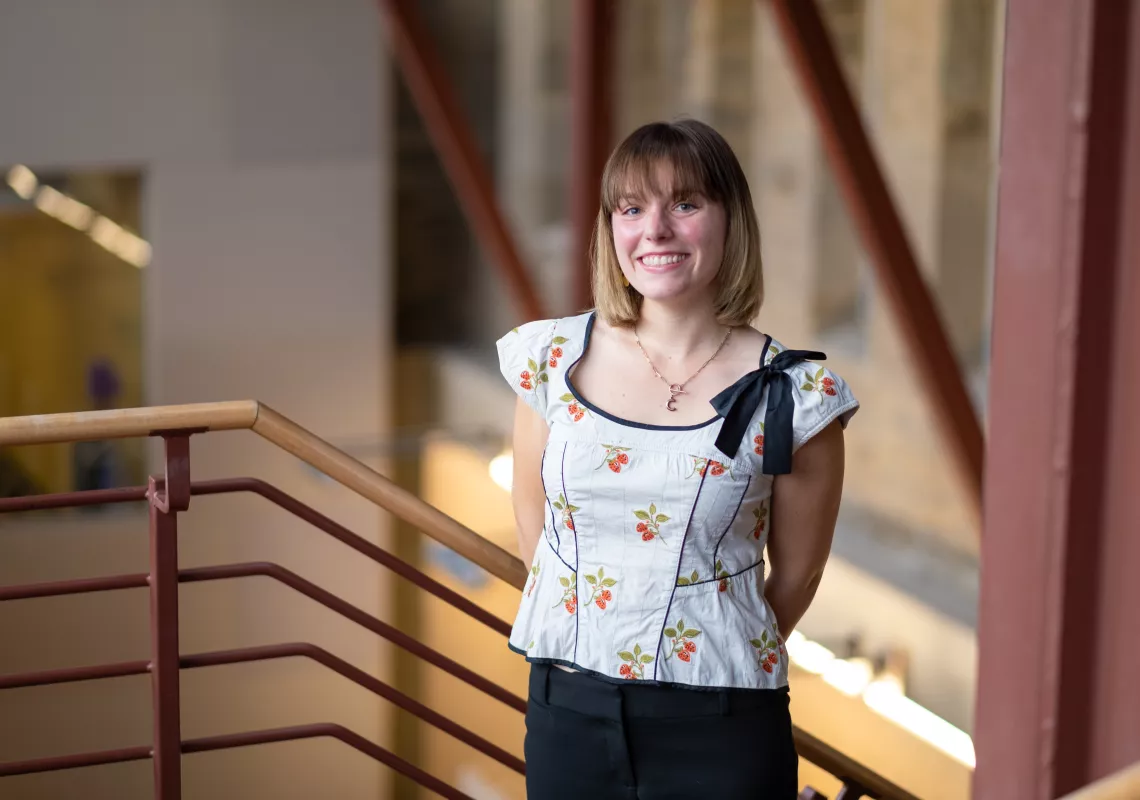 Caroline Robertson standing at the top of Carpenter Library stairs