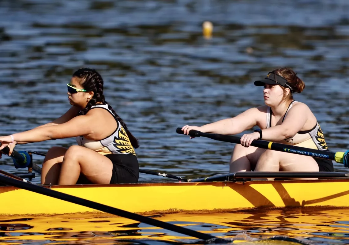 two students rowing