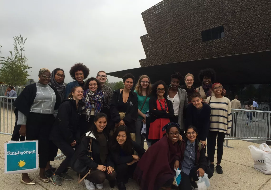 Students pose in front of the National Museum of African American History and Culture
