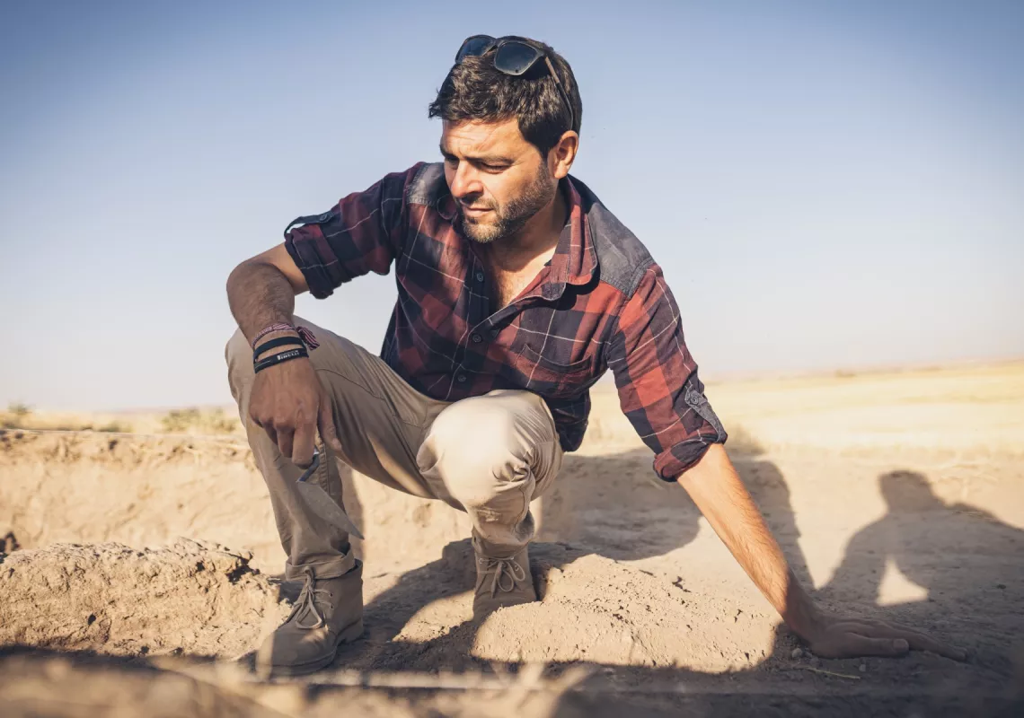 Rocco Palermo leaning over an excavation site