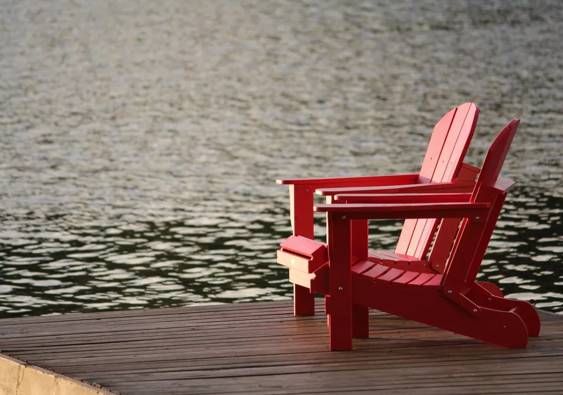 Adirondack chairs by the water
