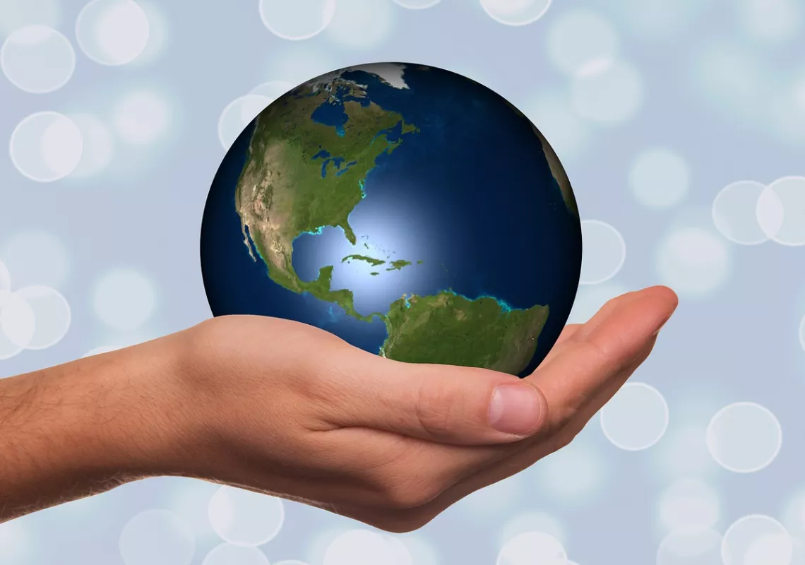 Hand holding a globe