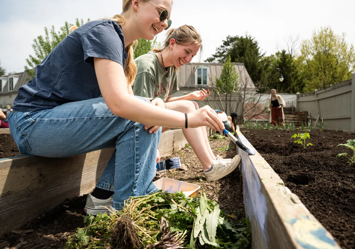Clara Thomas ’26 and Sophie Sweeting ’26 work in the Community Garden. Photo by Caroline Bittenbender.