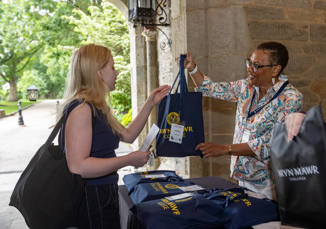 Bryn Mawr’s Chief Enrollment Officer Cheryl Lynn Horsey check's a student in.