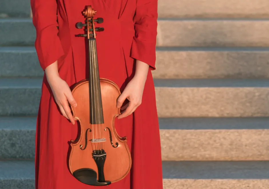 woman in red with violin stock