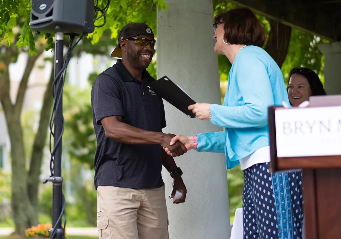 Gary Stroman accepts his McPherson Award from President Cassidy