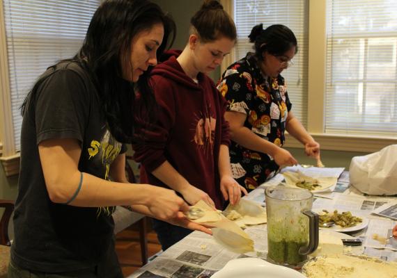 Migrations 360° students put together tamales in the SGA kitchen.