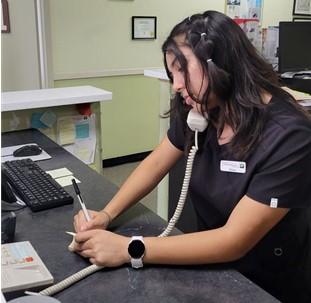 Diana taking phone calls at the front desk 