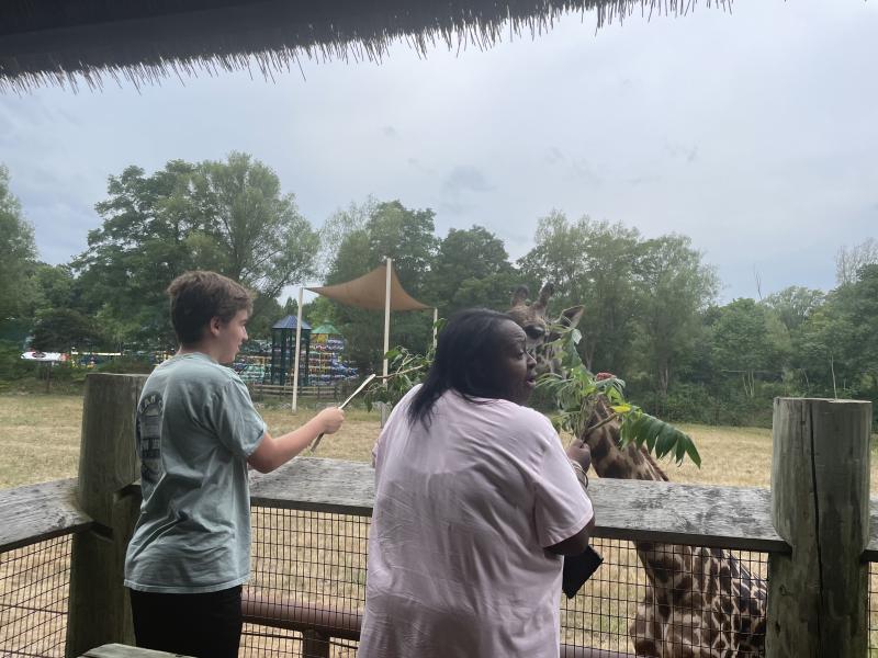 Isabel Oalicen at the Franklin Park Zoo feeding a giraffe