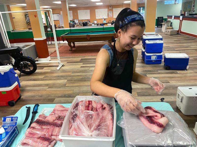 Amy Tse filleting fish