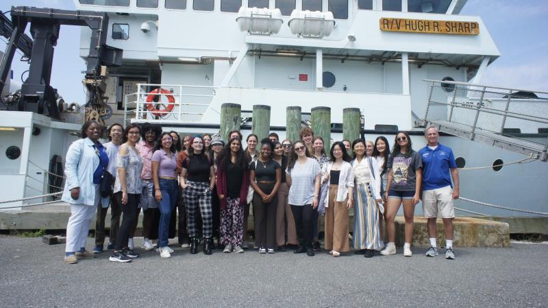 Group photo outside of a ferry. 