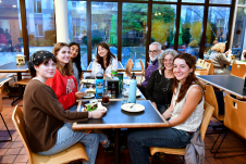 Family sitting and eating in New Dorm Dining Hall