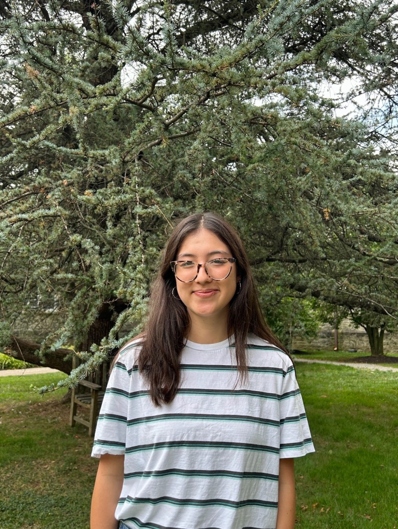 Girl wearing a striped shirt and smiling.