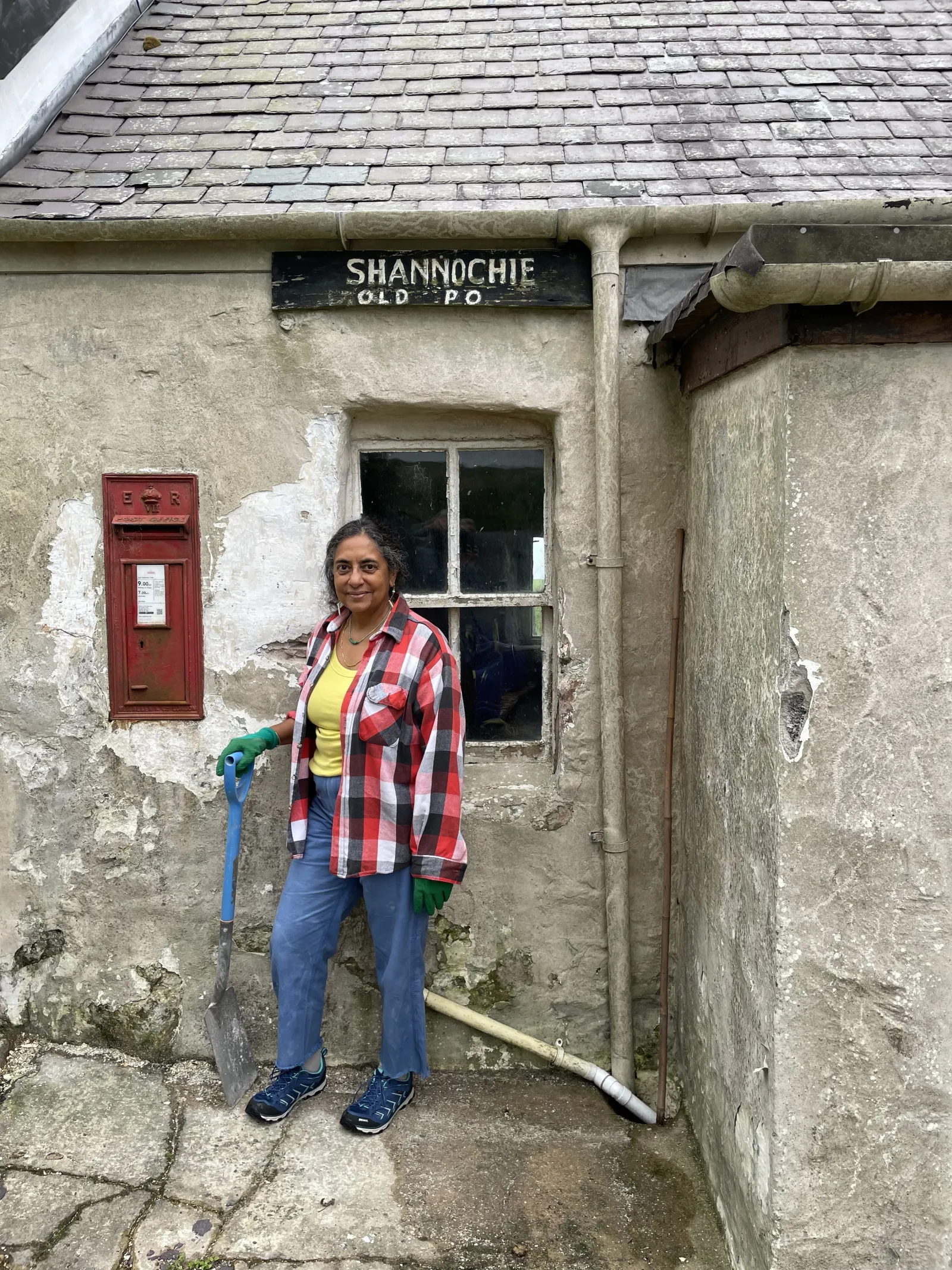 Michelle Valladares by the red postal box in her old post office on the Isle of Arran.