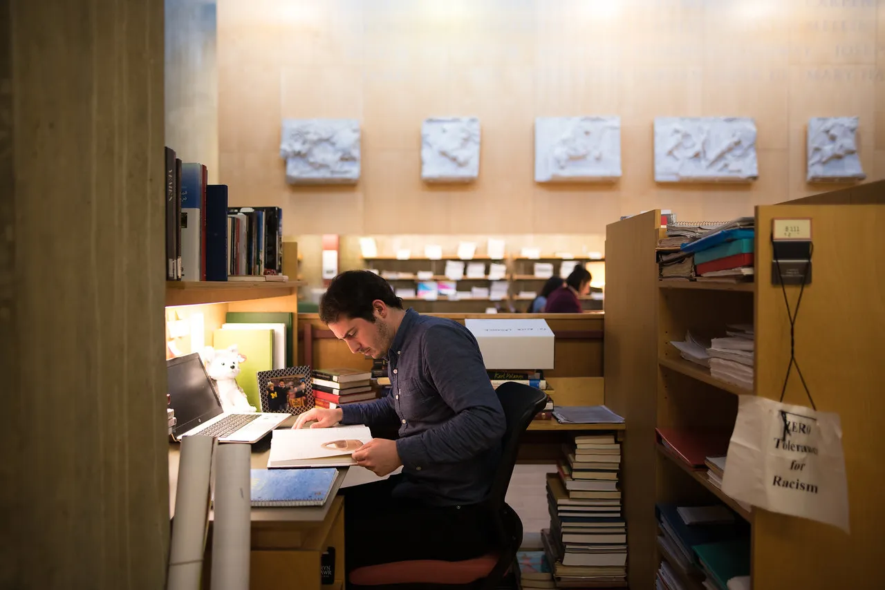 An archaeology Phd student studying in the library for her archaeology degree.