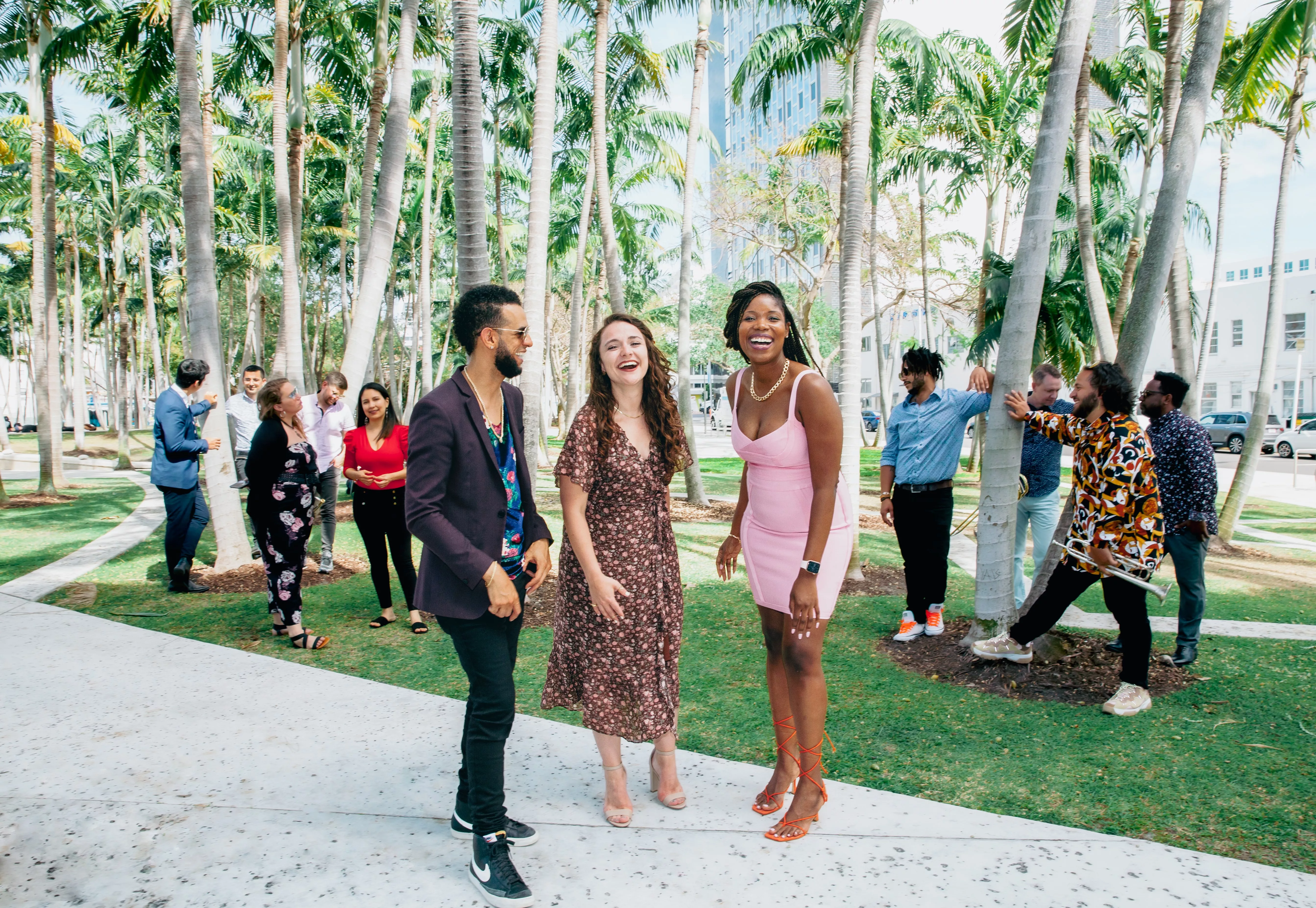 Band of musicians stand outside in front of trees